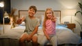 Two little lovely friendly caucasian children child kids boy girl brother sister looking camera waving hello in bedroom Royalty Free Stock Photo