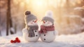 Two little lovely snowmen huging in the snow