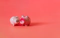 Two little pigs on a pink background. Composition for Valentine`s Day. Finance concept. Piggy bank, animals, figurines. Copy space Royalty Free Stock Photo