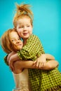 Two little red headed girls sisters hug each other warmly, express sincere relationship of love and care. Royalty Free Stock Photo