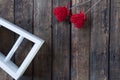 Two little red hearts for Valentine`s day on a brown wooden background. White frame Royalty Free Stock Photo