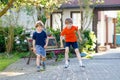 Two little school and preschool kids boys playing hopscotch on playground Royalty Free Stock Photo