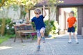 Two little school and preschool kids boys playing hopscotch on playground Royalty Free Stock Photo