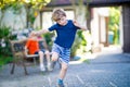 Two little school and preschool kids boys playing hopscotch on playground Royalty Free Stock Photo