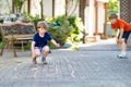 Two little school and preschool kids boys playing hopscotch on playground Royalty Free Stock Photo