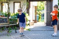 Two little school and preschool kids boys playing hopscotch on playground Royalty Free Stock Photo