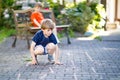 Two little school and preschool kids boys playing hopscotch on playground Royalty Free Stock Photo