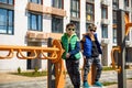 Two little school and preschool kids boys playing on playground outdoors together. children having competition standing on log Royalty Free Stock Photo