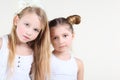 Two little serious girl in white clothes look at camera Royalty Free Stock Photo