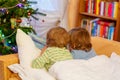 Two little sibling boys reading book on Christmas Royalty Free Stock Photo