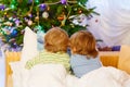 Two little sibling boys reading book on Christmas Royalty Free Stock Photo