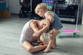 Two little siblings children quarrelling after playing at room at house. Crying offended toddler boy arguing with elder sister. Royalty Free Stock Photo