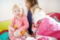 Two little sisters in bed on sunny morning Royalty Free Stock Photo