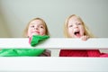 Two little sisters fooling around, playing and having fun in twin bunk bed Royalty Free Stock Photo