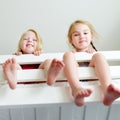 Two little sisters fooling around, playing and having fun in twin bunk bed Royalty Free Stock Photo