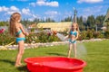 Two little sisters frolicing, splashing and having Royalty Free Stock Photo