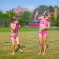 Two little sisters frolicing and splashing in Royalty Free Stock Photo