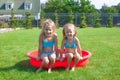 Two little sisters frolicing and splashing in Royalty Free Stock Photo