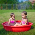 Two little sisters frolicing and splashing in Royalty Free Stock Photo