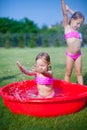 Two little sisters frolicing and splashing in Royalty Free Stock Photo