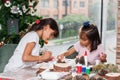 Two little sisters having fun while making christmas Nativity crafts with at home Royalty Free Stock Photo