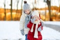 Two little sisters having fun on snowy winter day Royalty Free Stock Photo