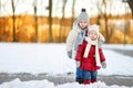 Two little sisters having fun on snowy winter day Royalty Free Stock Photo