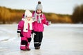 Two little sisters having fun on snowy winter day Royalty Free Stock Photo