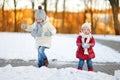 Two little sisters having fun on snowy winter day Royalty Free Stock Photo