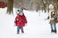 Two little sisters having fun on snowy winter day Royalty Free Stock Photo