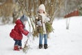 Two little sisters having fun on snowy winter day Royalty Free Stock Photo