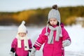 Two little sisters having fun on snowy winter day Royalty Free Stock Photo