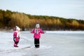 Two little sisters having fun on snowy winter day Royalty Free Stock Photo