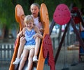 Two little sisters going down slide Royalty Free Stock Photo