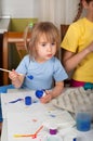 Two little sisters painting on Easter eggs