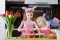 Two little sisters painting Easter eggs Royalty Free Stock Photo