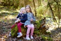 Two little sisters picking the first flowers of spring Royalty Free Stock Photo