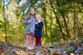 Two little sisters picking the first flowers of spring Royalty Free Stock Photo