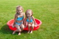 Two little sisters in small pool have fun Royalty Free Stock Photo