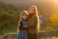 Two little sisters at sunset in the fall in nature. Royalty Free Stock Photo