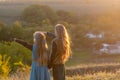 Two little sisters at sunset in the fall in nature. Royalty Free Stock Photo