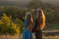 Two little sisters at sunset in the fall in nature. Royalty Free Stock Photo