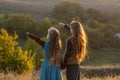 Two little sisters at sunset in the fall in nature. Royalty Free Stock Photo