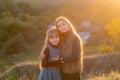 Two little sisters at sunset in the fall in nature. Royalty Free Stock Photo