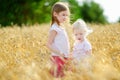 Two little sisters in wheat field on summer day Royalty Free Stock Photo