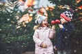 Two little smiling kids, boy and girl eating crystalized sugared apple on German Christmas market. Happy friends in Royalty Free Stock Photo