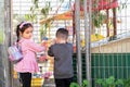 Two little students outside a preschool building. Royalty Free Stock Photo