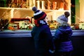 Two little toddlers, boy and girl looking on car toys in a window on Christmas time season. Fascinated children dreaming Royalty Free Stock Photo