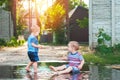 Two little toddlers run barefoot through puddles in summer Royalty Free Stock Photo