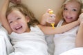 Two little twin sisters, play doctors with syringe Royalty Free Stock Photo